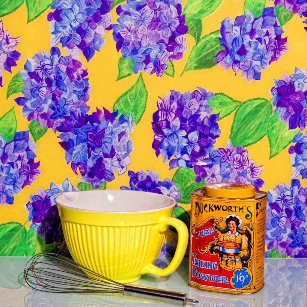 Emma Britton Blue Hydrangea with yellow background splashback